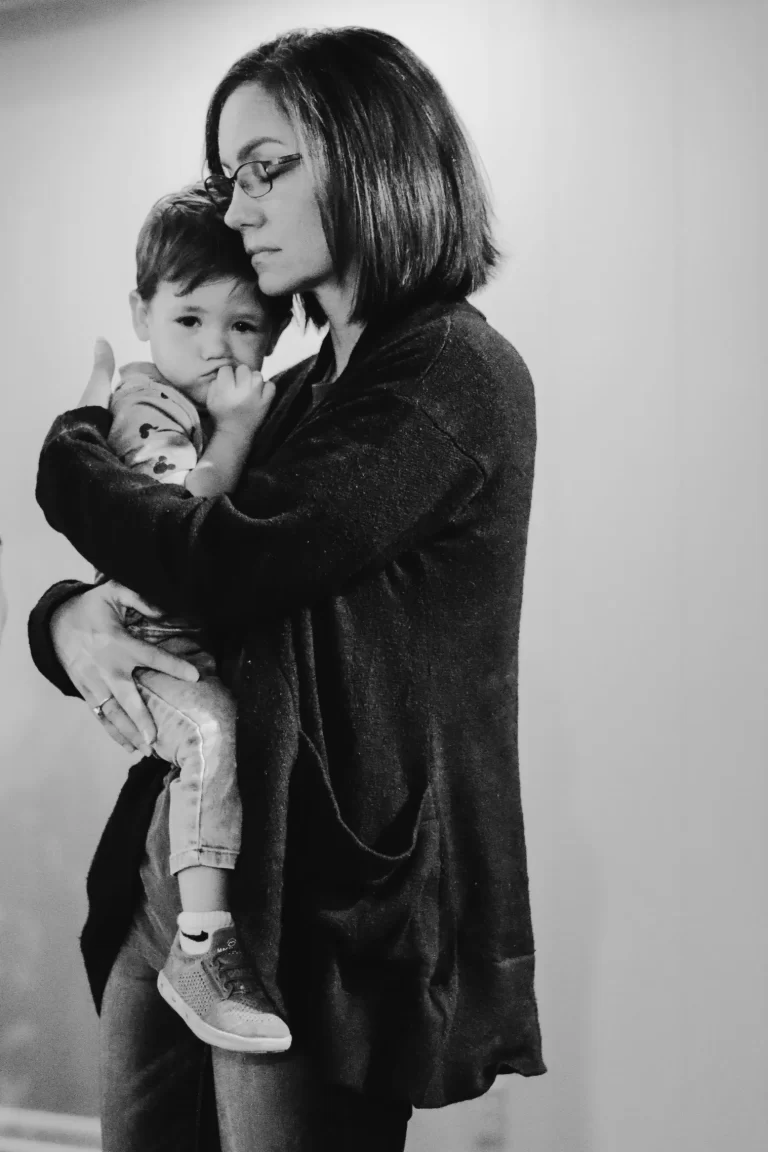 Woman holding child at Trinity Church Palestine, Texas