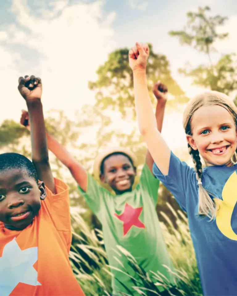 Multicultural Kids holding hands in the air.