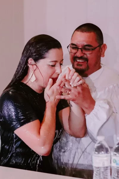 A woman is baptized by a pastor at Trinity Church Palestine.
