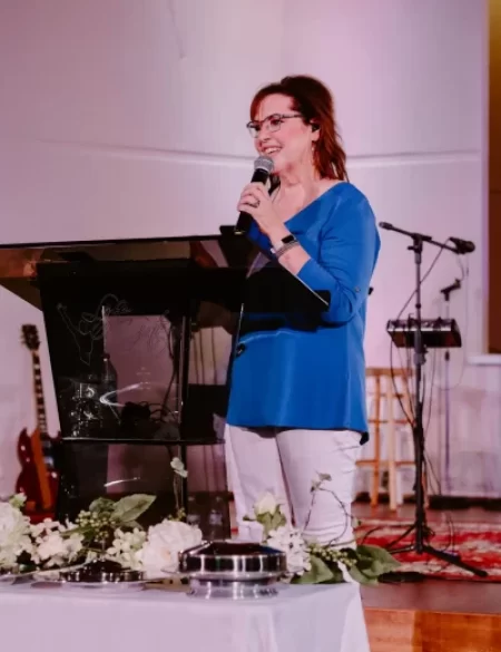 A woman speaking in worship services at Trinity Church Palestine, Texas.